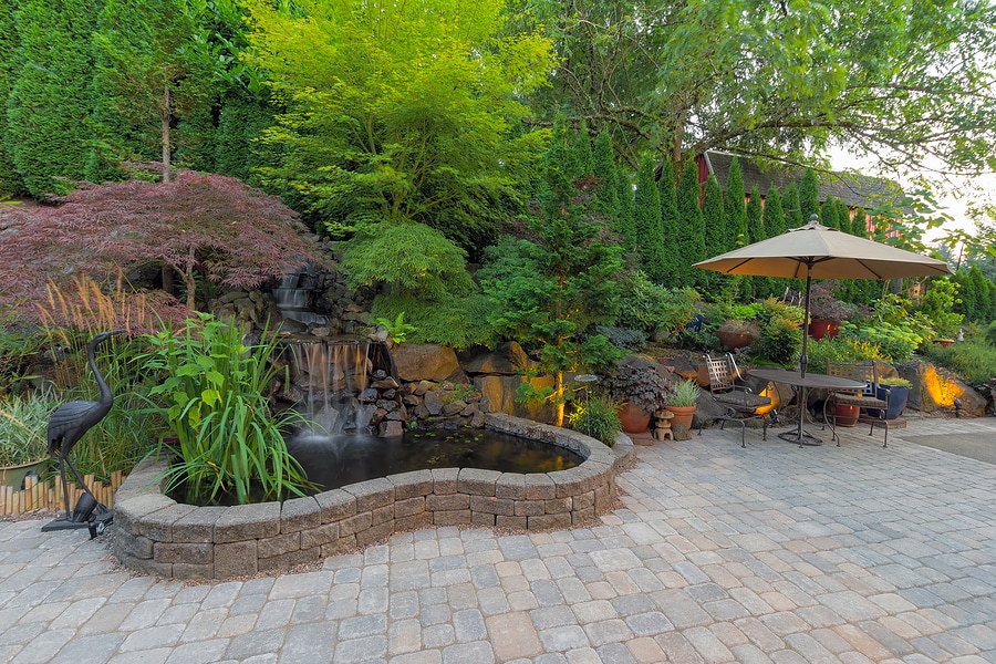 Beautiful backyard, natural stone paved patio with complementary landscaping
